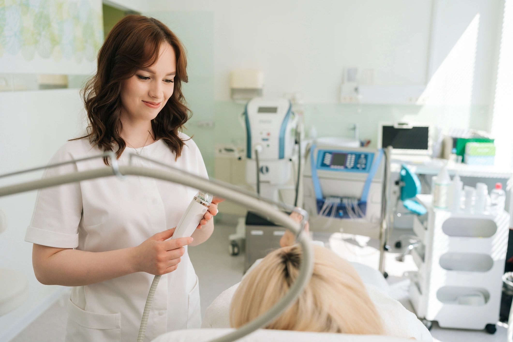 Clinician consulting a patient before a facial treatment