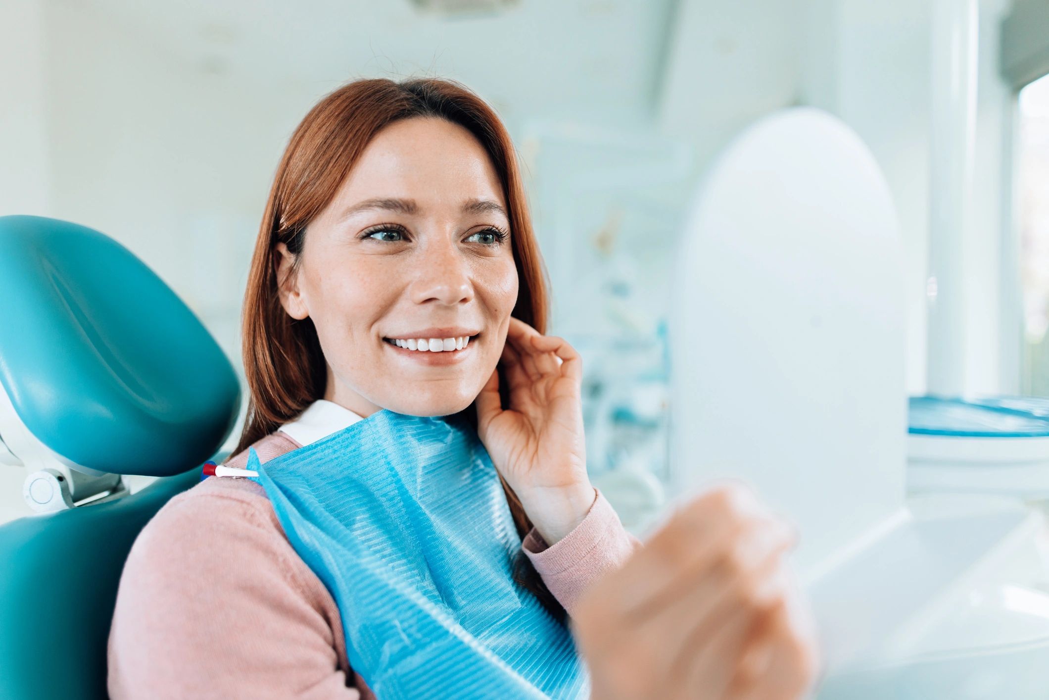 Patient smiling after a dental checkup in a modern clinic