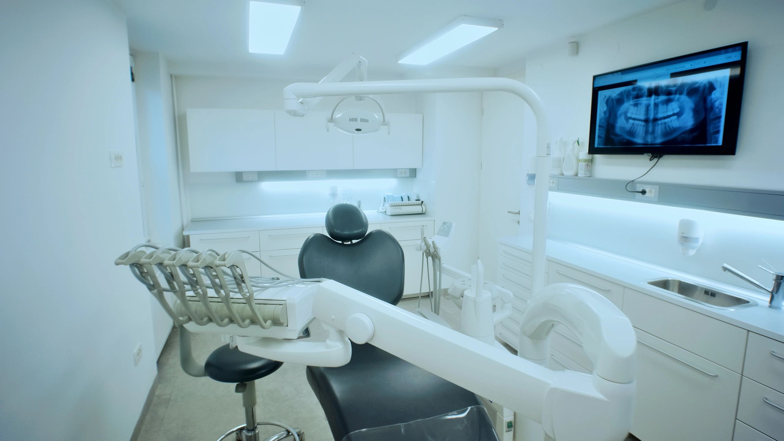 Dental clinic treatment room with chair and equipment