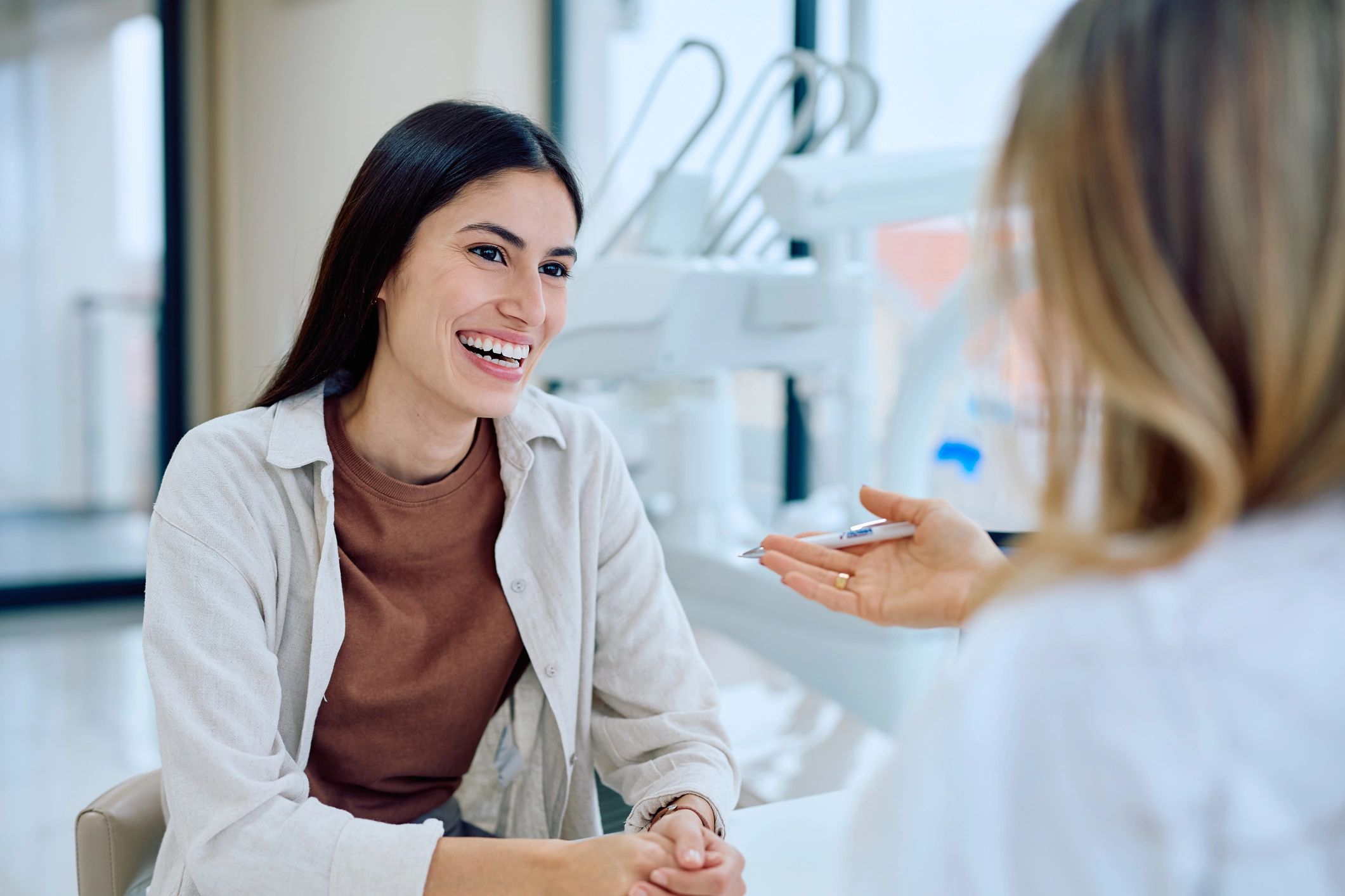 Dentist consulting with a patient in a modern clinic
